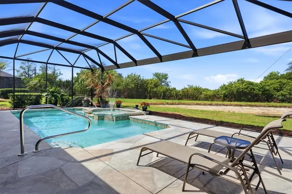 a view of swimming pool with seating space and furniture