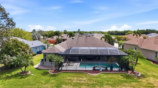 an aerial view of a house with garden space and sitting area