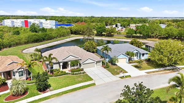 an aerial view of multiple houses with a lake view