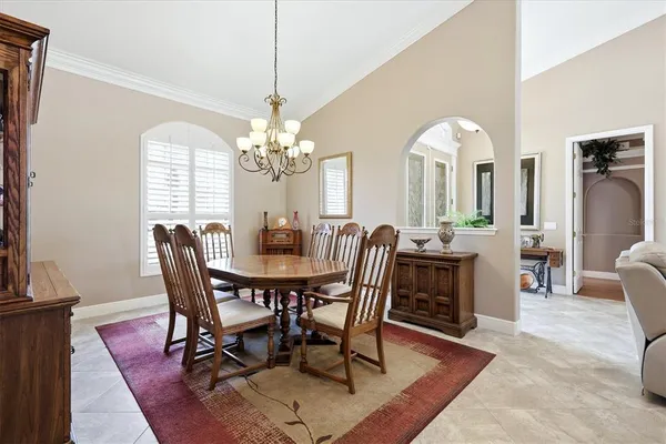 a view of a dining room with furniture and a chandelier