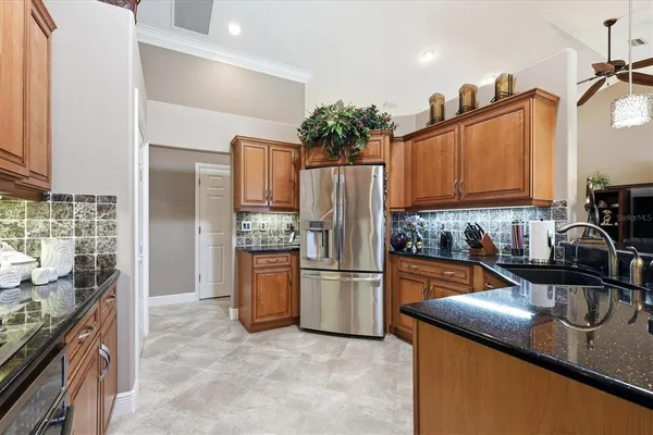 a kitchen with refrigerator and cabinets
