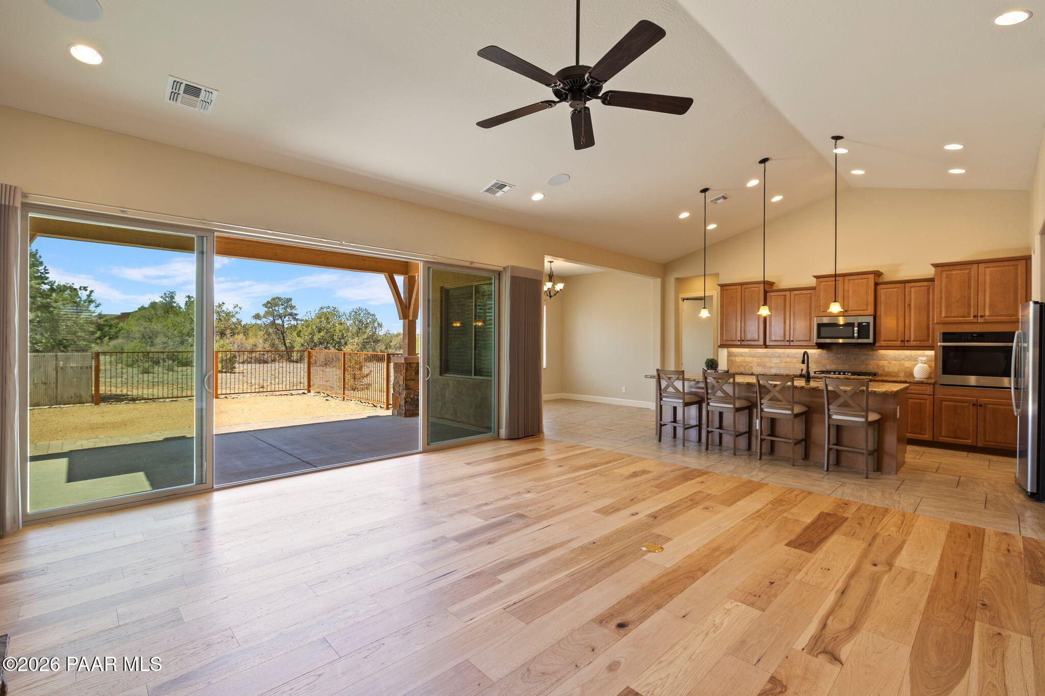 4850 West Three Forks Road Prescott, AZ 86305 - Photo 12 of 69 a view of a kitchen with dining room and wooden floor