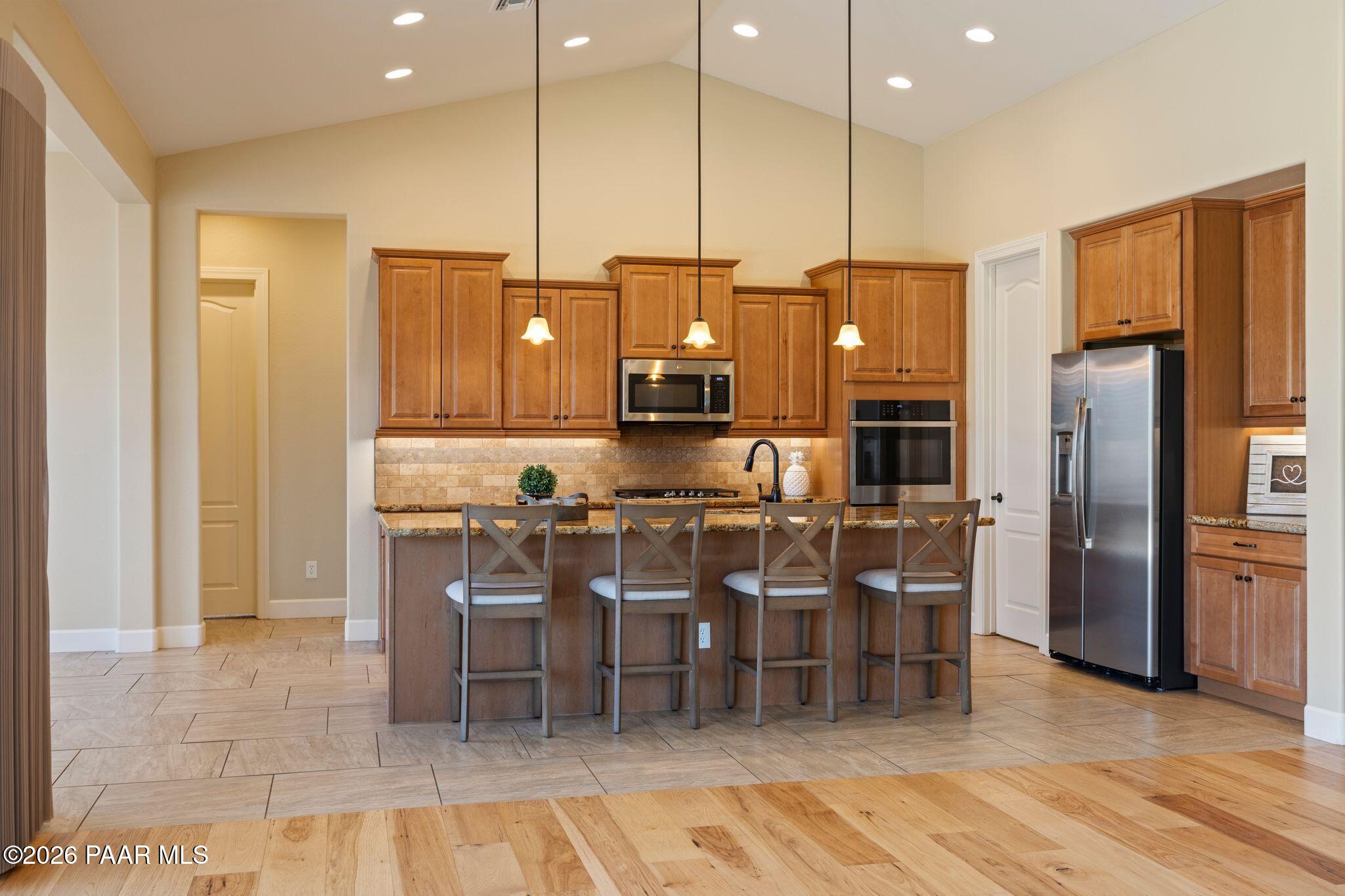 4850 West Three Forks Road Prescott, AZ 86305 - Photo 13 of 69 a kitchen with cabinets and chairs