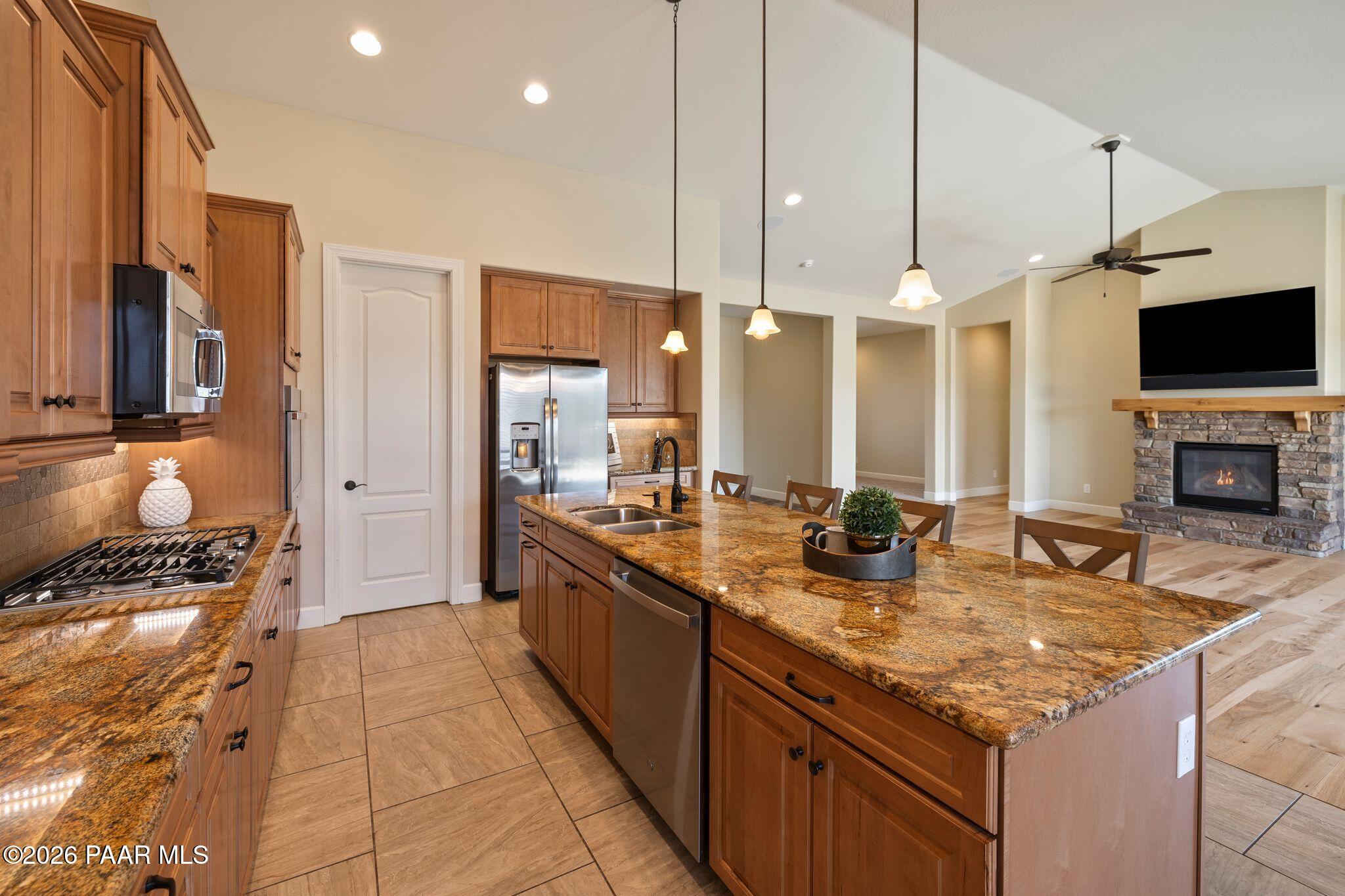 4850 West Three Forks Road Prescott, AZ 86305 - Photo 15 of 69 a kitchen with granite countertop a sink and a stove