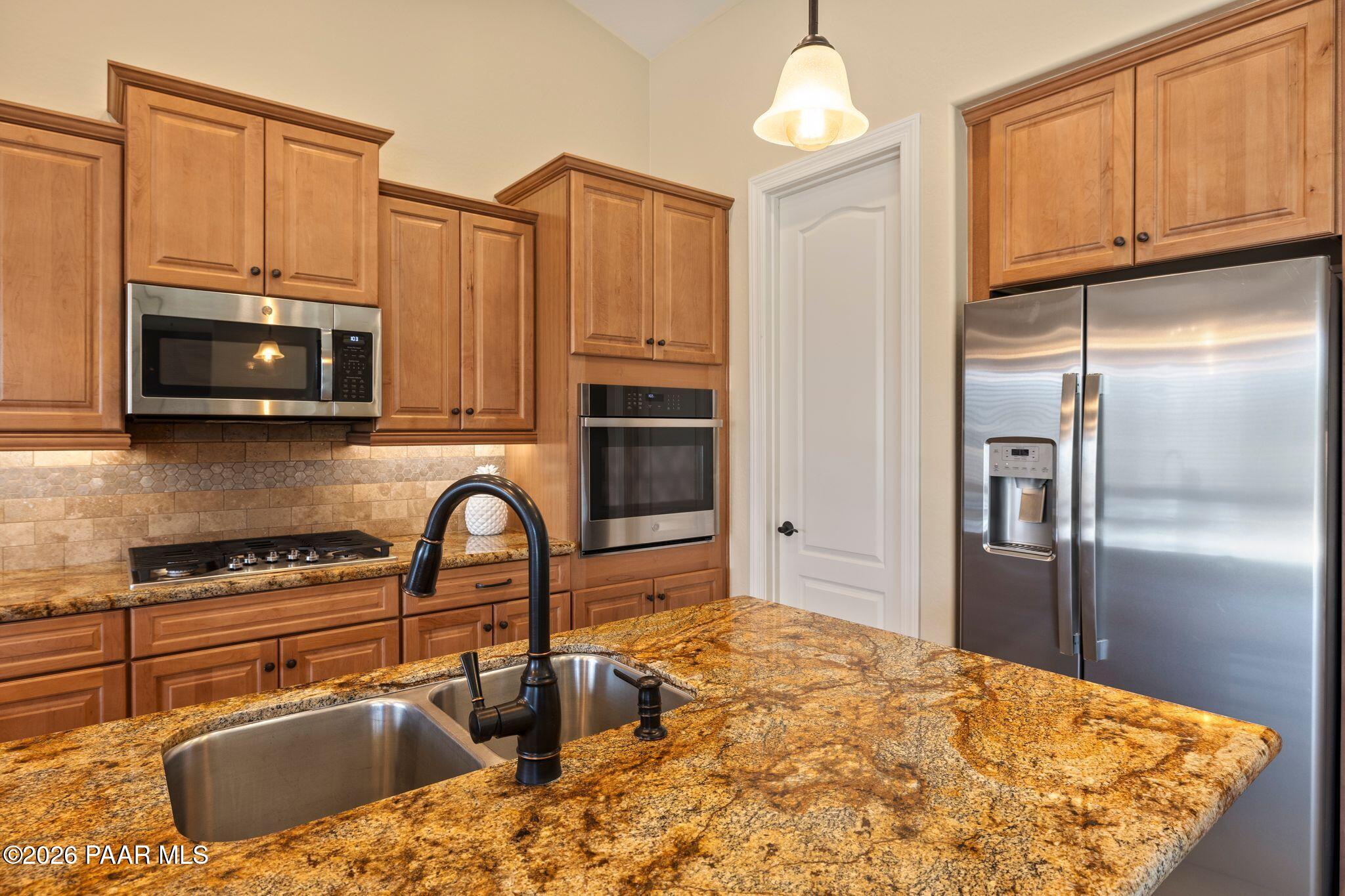 4850 West Three Forks Road Prescott, AZ 86305 - Photo 17 of 69 a kitchen with stainless steel appliances granite countertop a refrigerator a stove top oven a sink and dishwasher