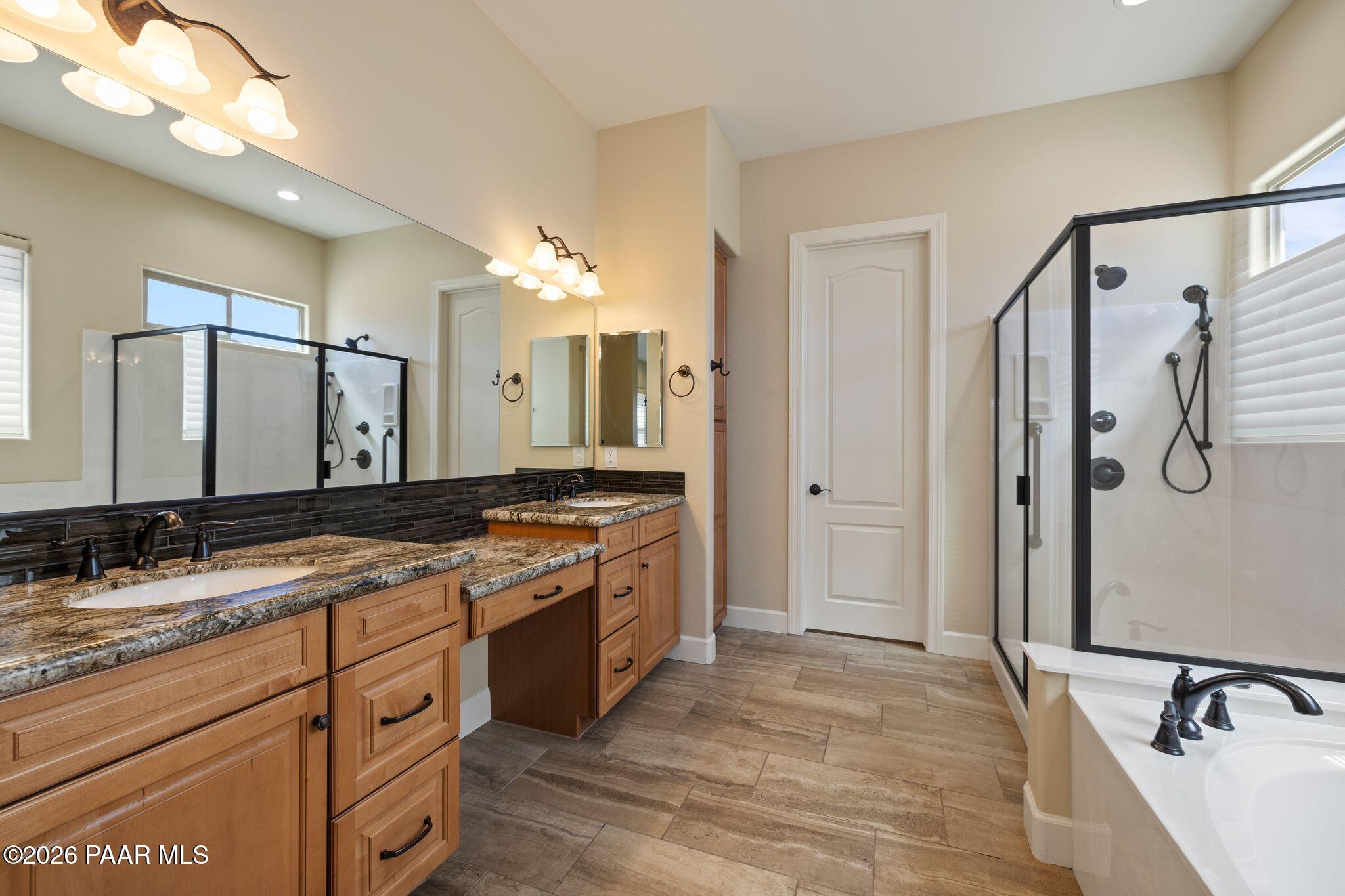 4850 West Three Forks Road Prescott, AZ 86305 - Photo 26 of 69 a spacious bathroom with a granite countertop sink mirror and double