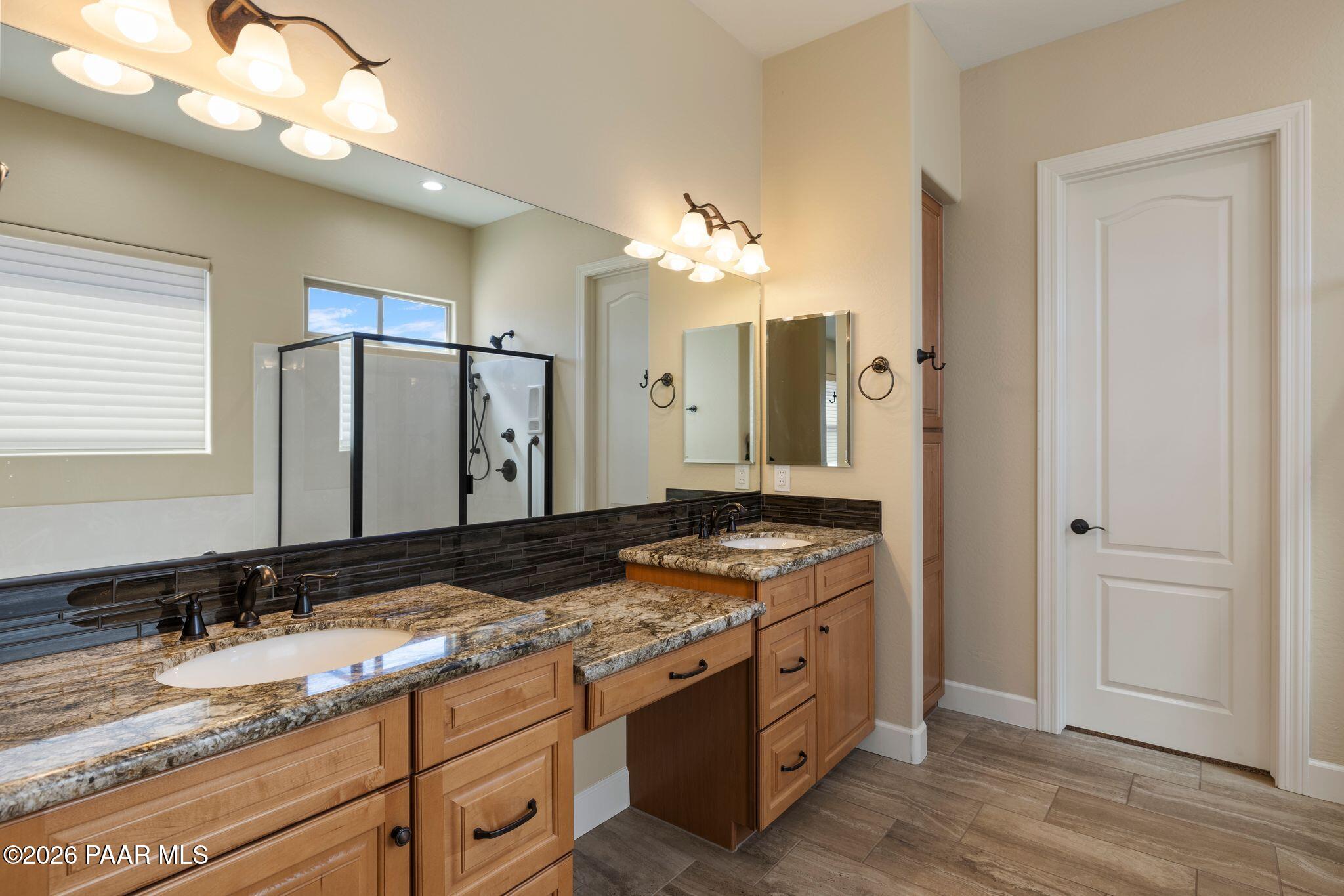 4850 West Three Forks Road Prescott, AZ 86305 - Photo 27 of 69 a bathroom with a granite countertop sink and a mirror