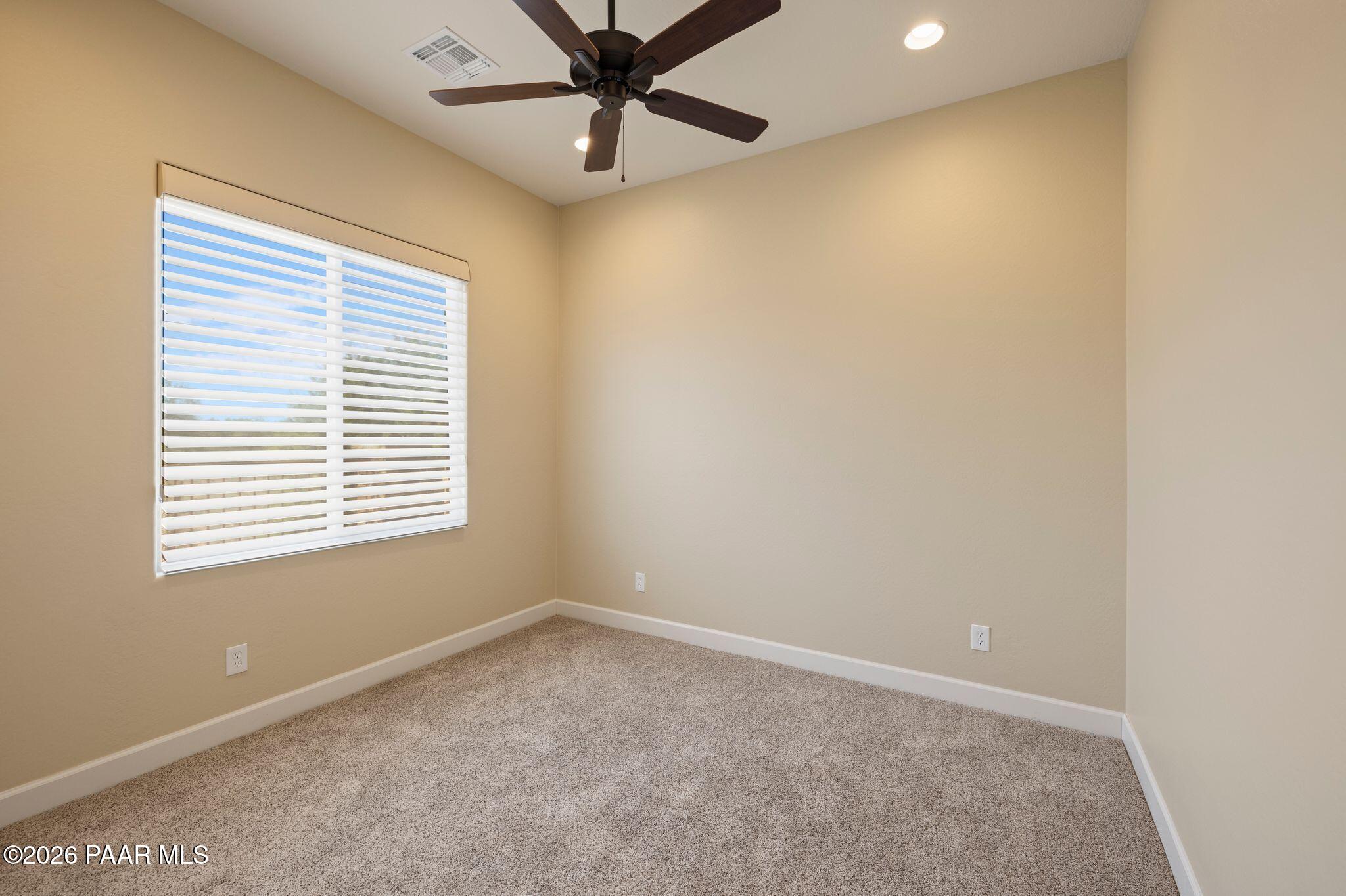 4850 West Three Forks Road Prescott, AZ 86305 - Photo 31 of 69 an empty room with a window and a fan