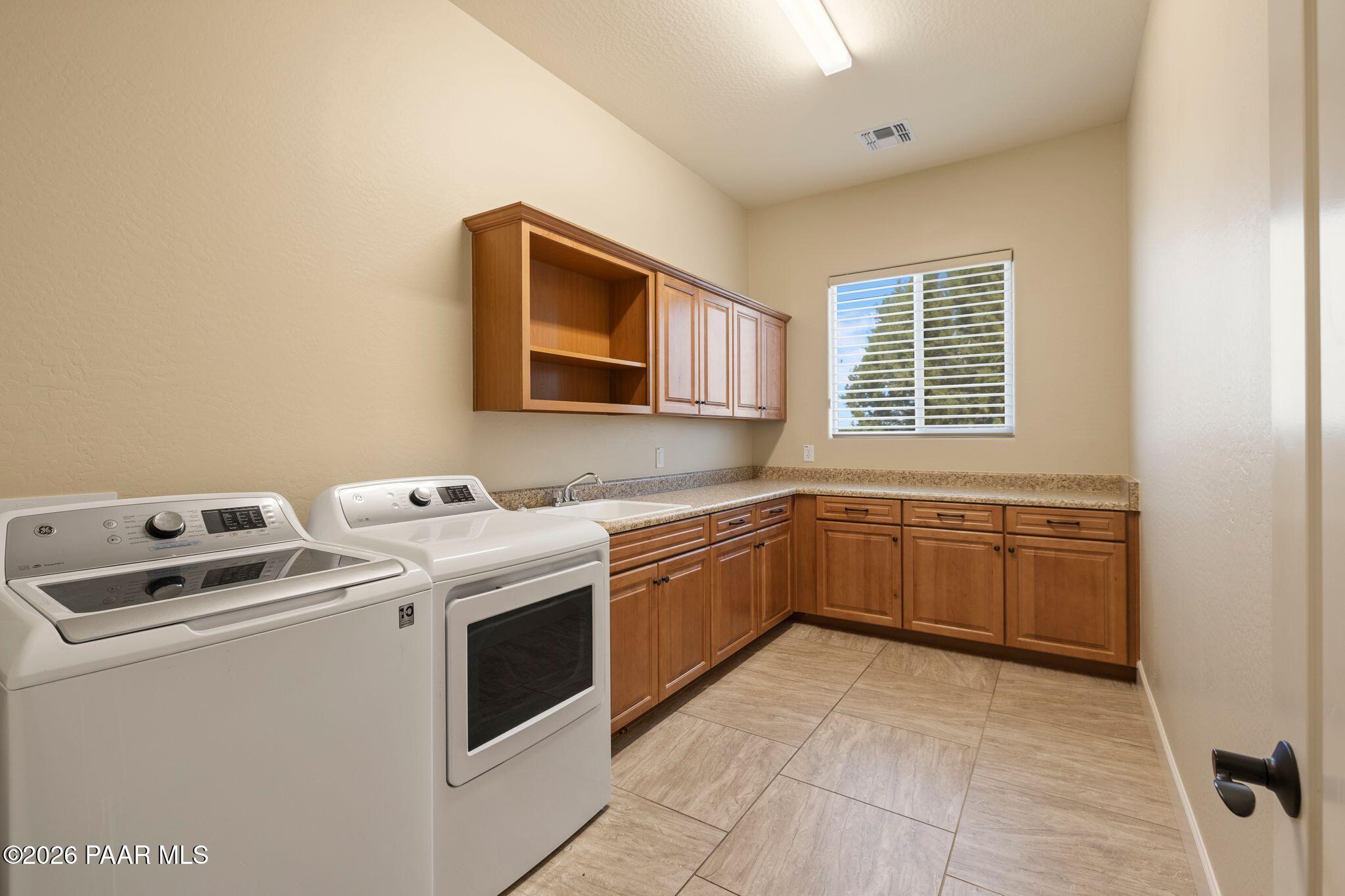 4850 West Three Forks Road Prescott, AZ 86305 - Photo 37 of 69 a kitchen with a stove top oven sink and cabinets