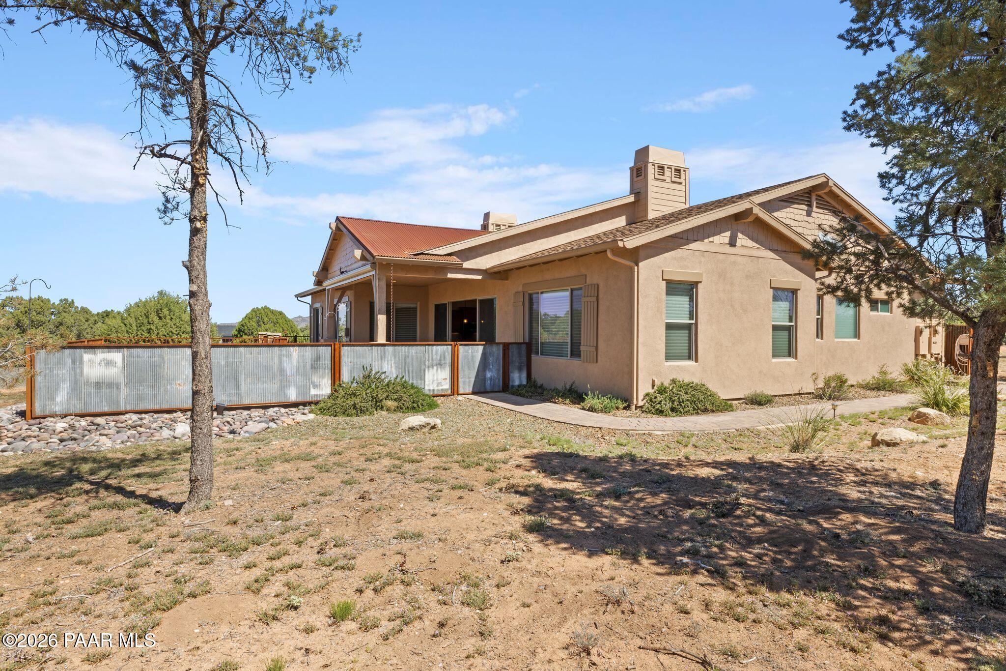 4850 West Three Forks Road Prescott, AZ 86305 - Photo 41 of 69 a view of a house with a yard and chandelier