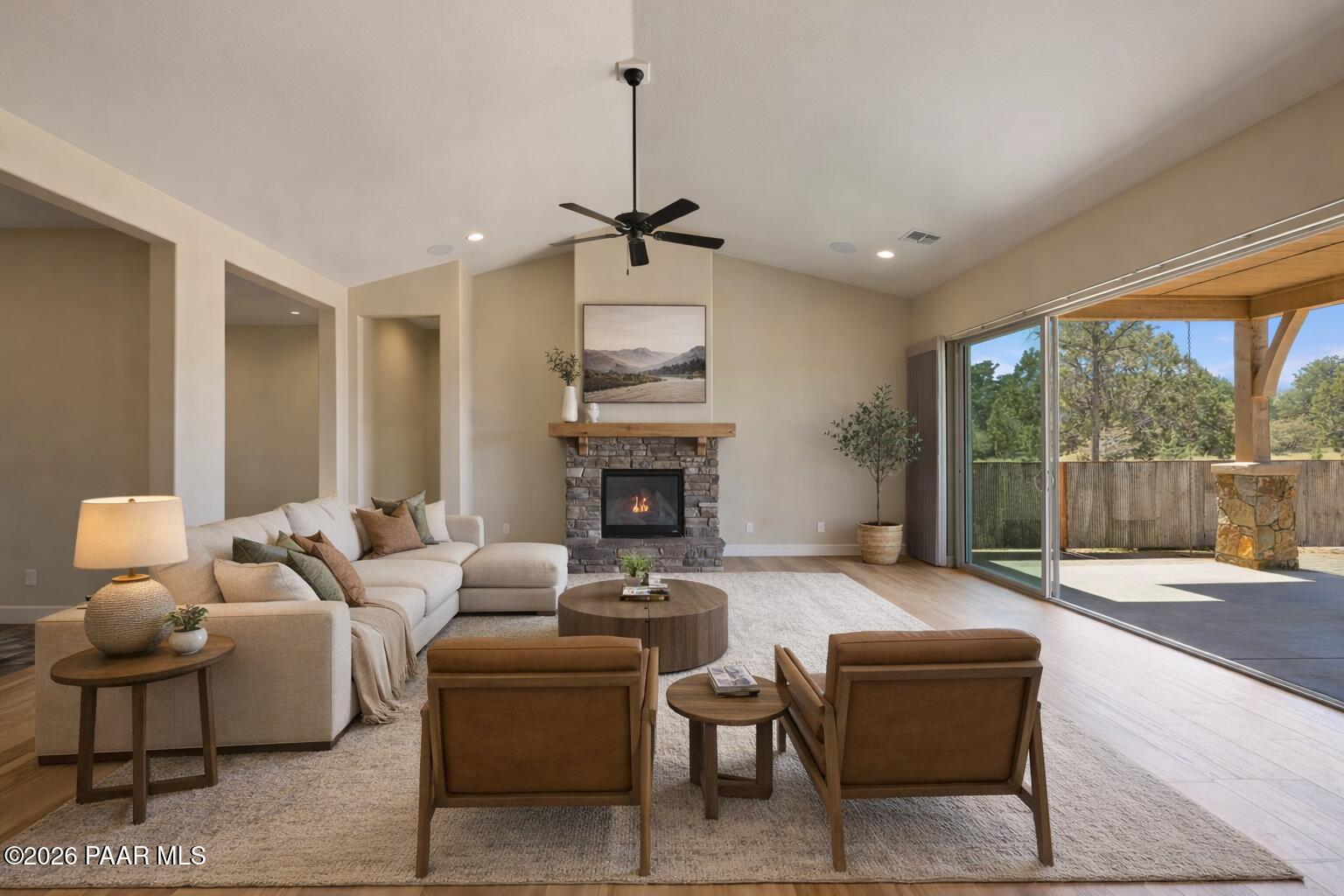 4850 West Three Forks Road Prescott, AZ 86305 - Photo 7 of 69 a living room with furniture a large window and a fireplace