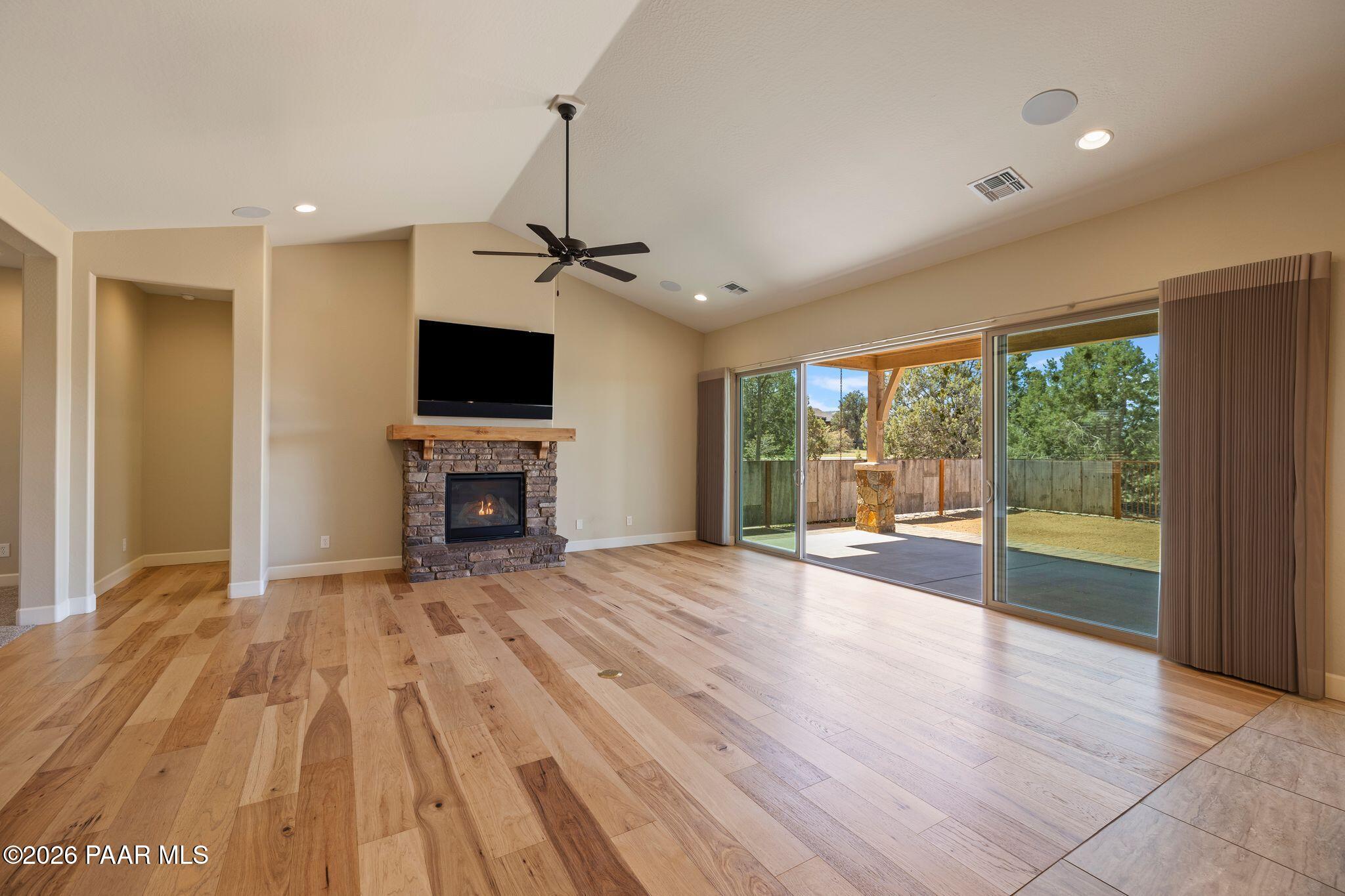 4850 West Three Forks Road Prescott, AZ 86305 - Photo 8 of 69 a view of empty room with wooden floor and fireplace