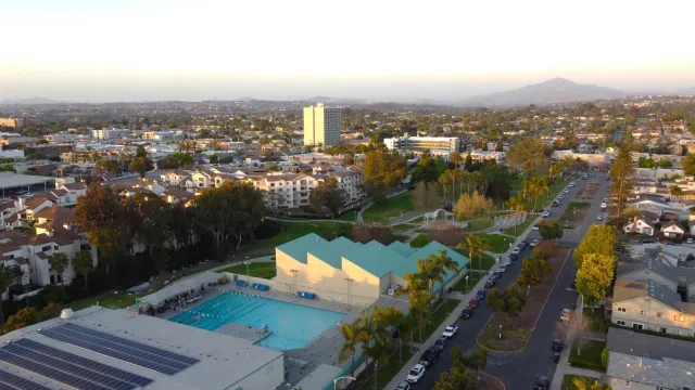 a bath tub sitting next to a blue sink and a rug