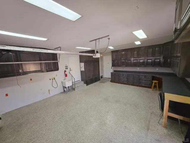 a open kitchen with cabinets and a wooden floor