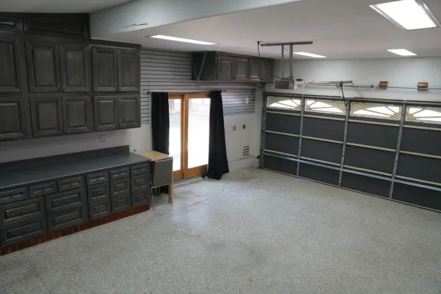 a open kitchen with cabinets and a window