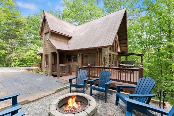 a view of a patio with a table chairs and a fire pit