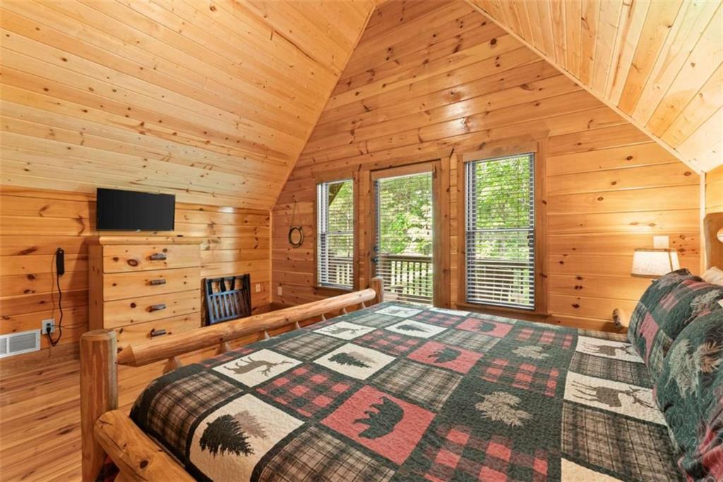 53 Elm Ridge Drive Cleveland, GA 30528 - Photo 26 of 60 a bedroom with a bed and a flat tv screen