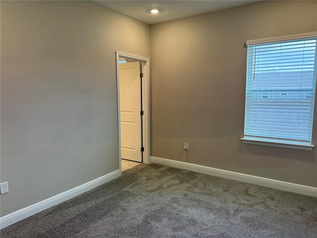 16434 Hamlin Hills Road Winter Garden, FL 34787 - Photo 24 of 50 a view of an empty room with a window
