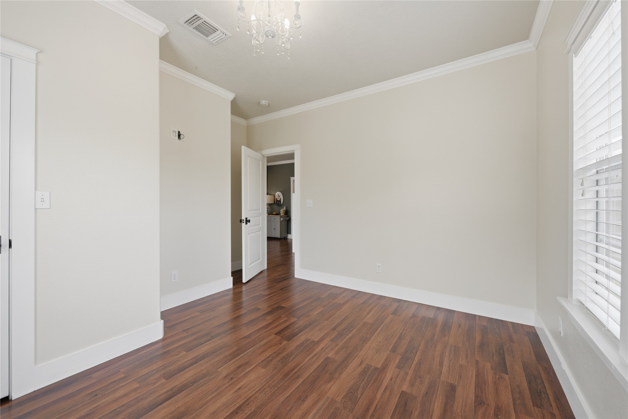 305 Affleck Road Brenham, TX 77833 - Photo 23 of 43 an empty room with wooden floor and windows