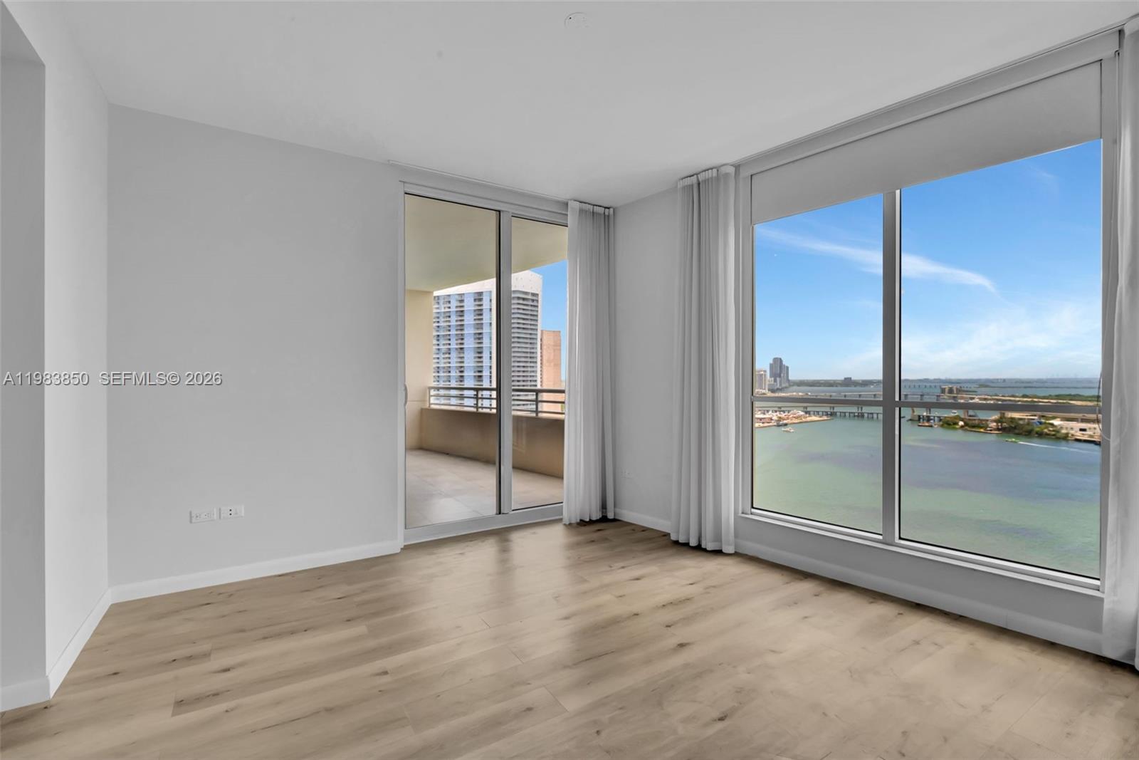 848 Brickell Key Drive, Unit 2602 Miami, FL 33131 - Photo 19 of 40 wooden floor and windows in an empty room