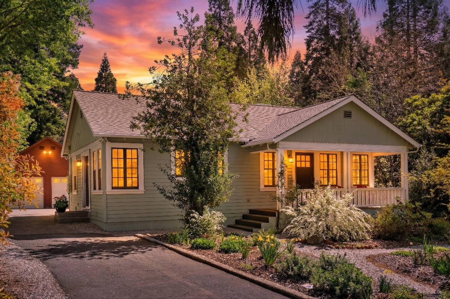a front view of a house with a yard and outdoor seating