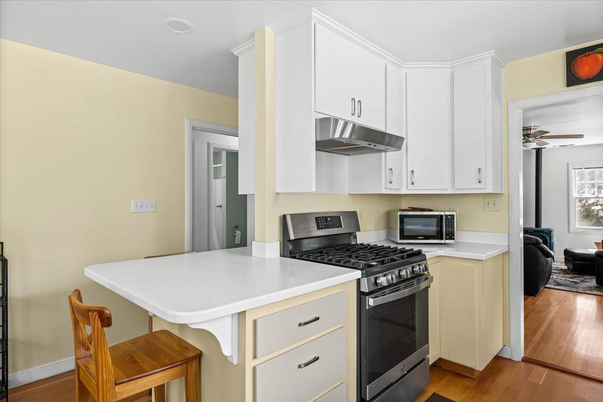 10041 Greenwood Road Grass Valley, CA 95945 - Photo 20 of 65 a kitchen with stainless steel appliances a stove a refrigerator a sink a stove and white cabinets