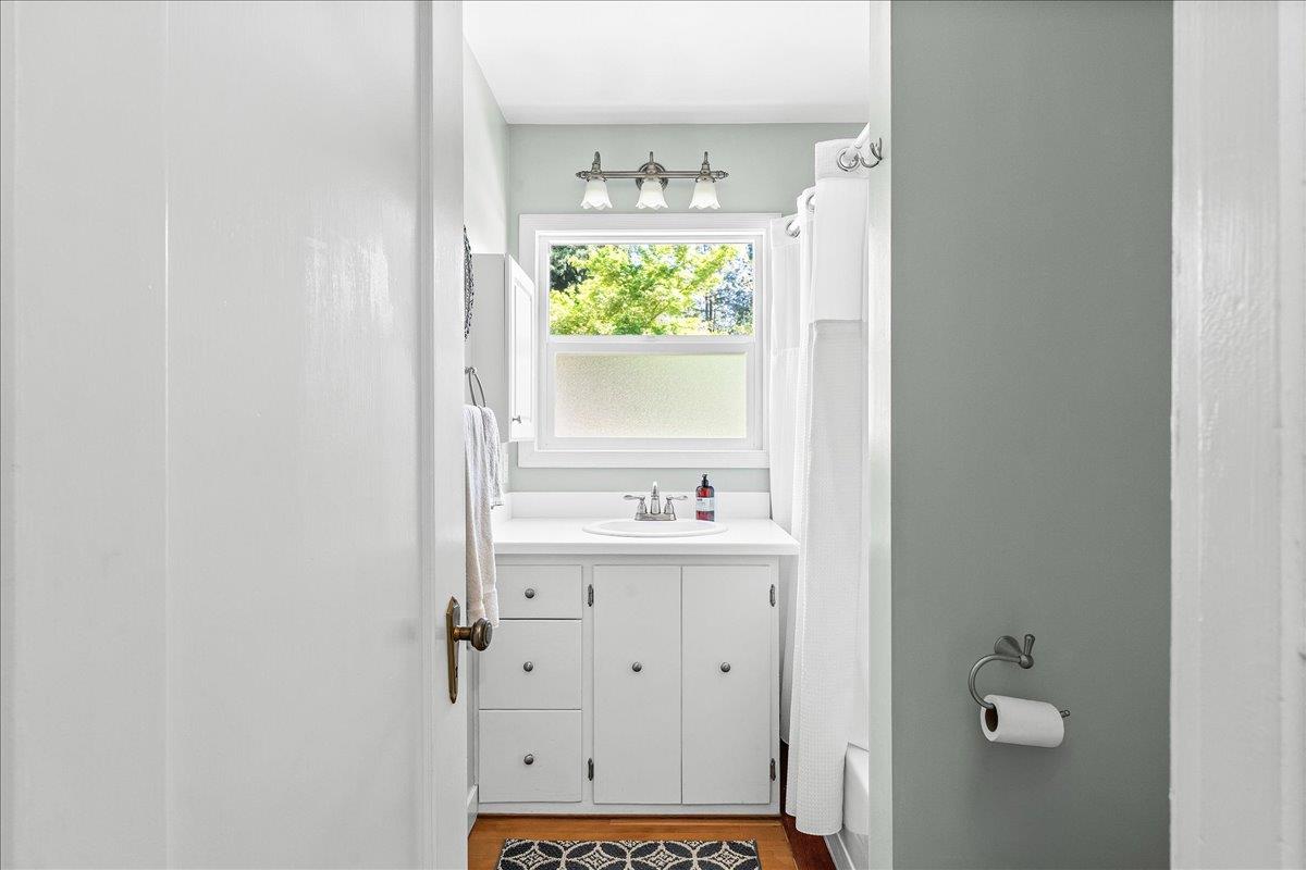 10041 Greenwood Road Grass Valley, CA 95945 - Photo 29 of 65 a bathroom with a granite countertop sink and a window