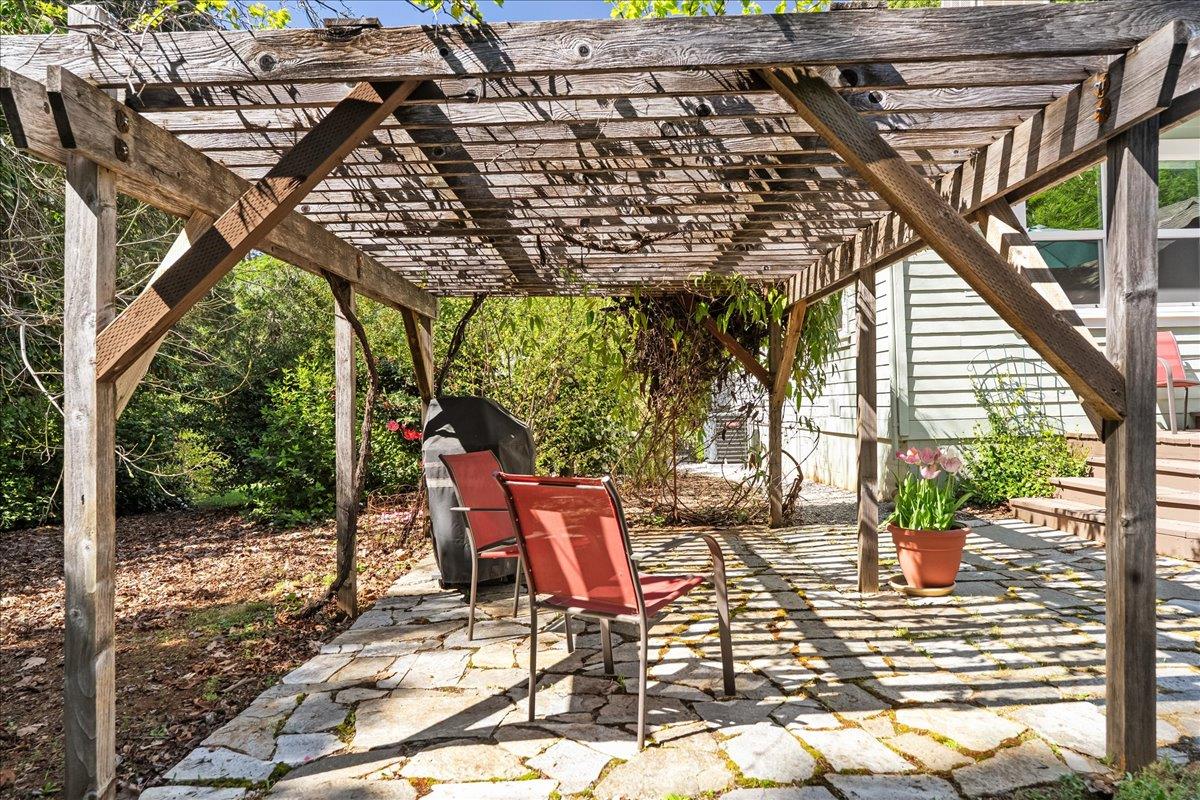 10041 Greenwood Road Grass Valley, CA 95945 - Photo 32 of 65 a patio with glass top table and chairs
