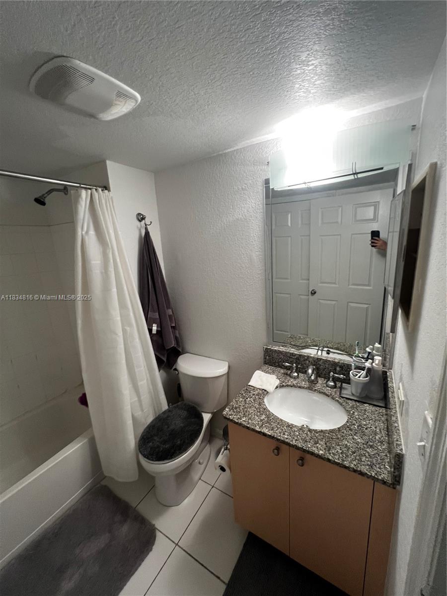 2548 Centergate Drive, Unit 301 Miramar, FL 33025 - Photo 12 of 12 a bathroom with a granite countertop sink toilet and shower
