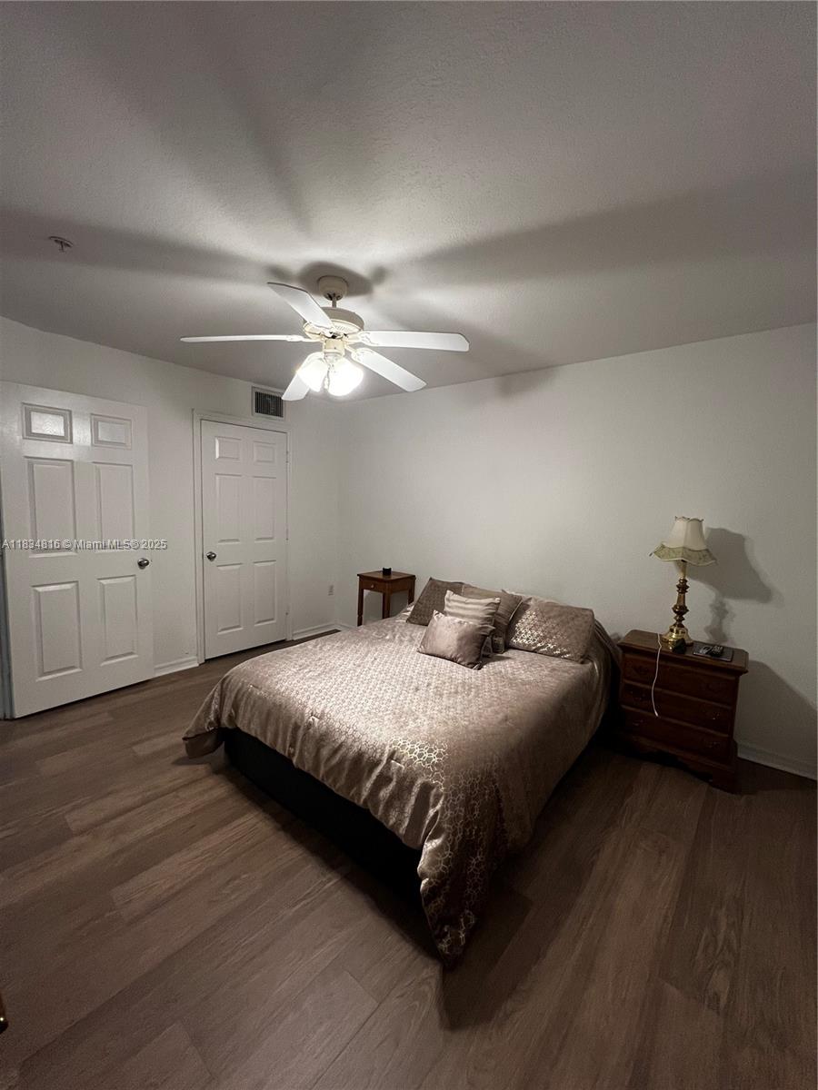 2548 Centergate Drive, Unit 301 Miramar, FL 33025 - Photo 9 of 12 a bedroom with a bed and closet