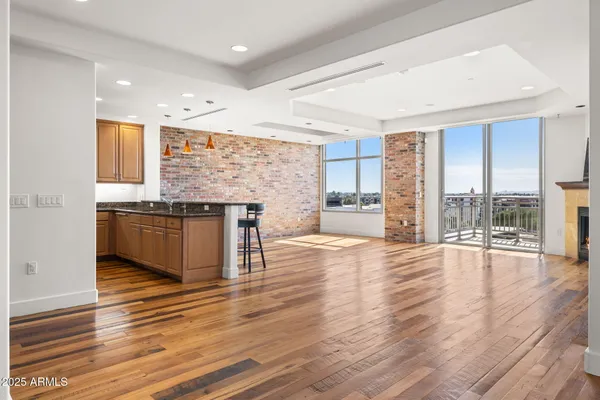 a view of kitchen with granite countertop cabinets and wooden floor