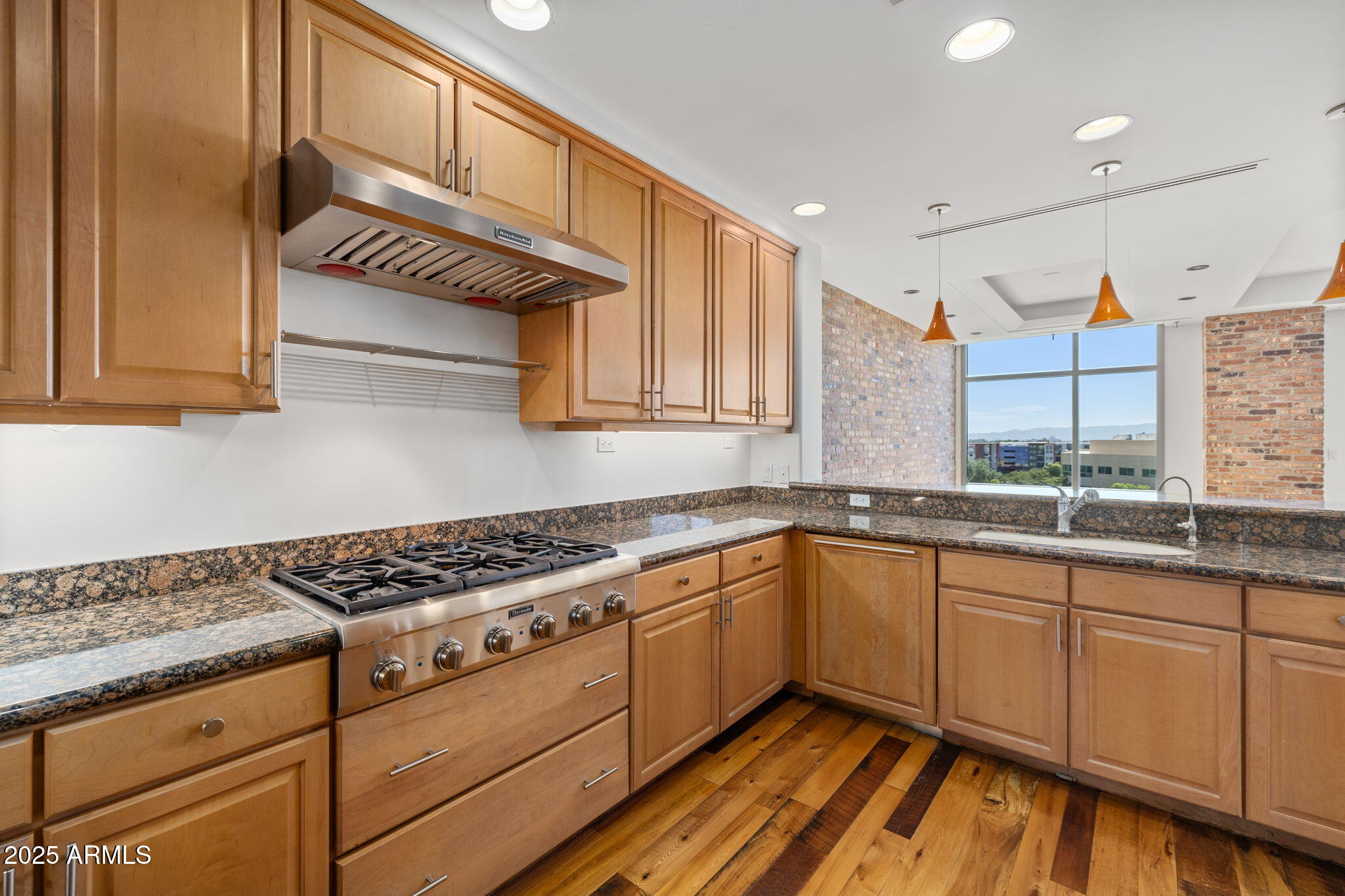 2211 East Camelback Road, Unit 607 Phoenix, AZ 85016 - Photo 11 of 41 a kitchen with granite countertop a sink and cabinets