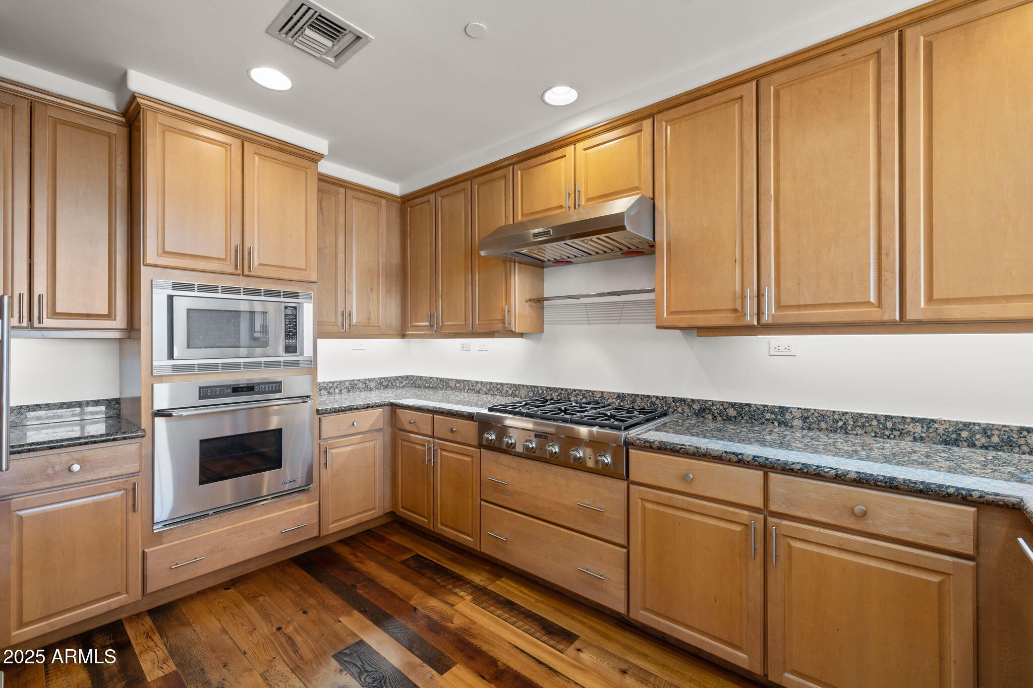 2211 East Camelback Road, Unit 607 Phoenix, AZ 85016 - Photo 12 of 41 a kitchen with granite countertop cabinets stainless steel appliances and a counter space