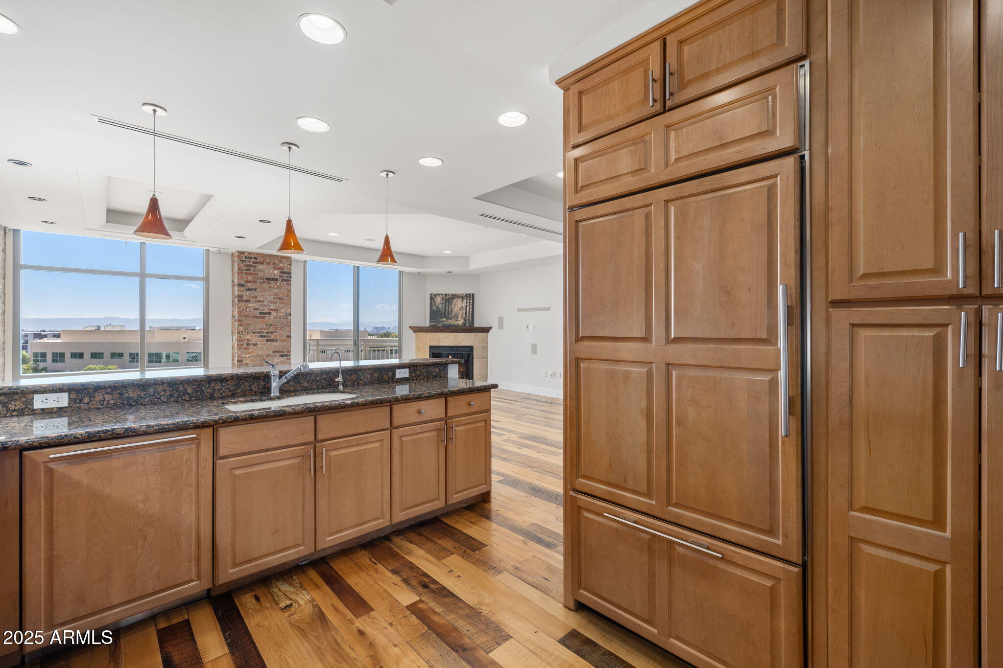 2211 East Camelback Road, Unit 607 Phoenix, AZ 85016 - Photo 13 of 41 a kitchen with stainless steel appliances granite countertop a refrigerator and a sink