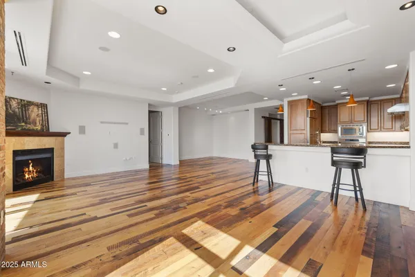 an empty room with a ceiling fan and carpet