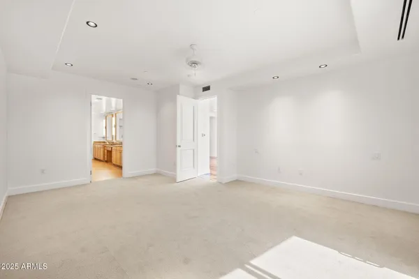 a spacious bedroom with a large bed and a windows