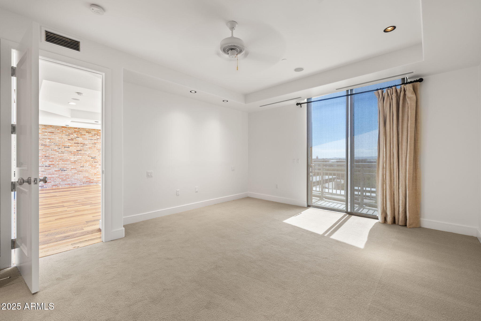 2211 East Camelback Road, Unit 607 Phoenix, AZ 85016 - Photo 18 of 41 a view of an empty room with a window