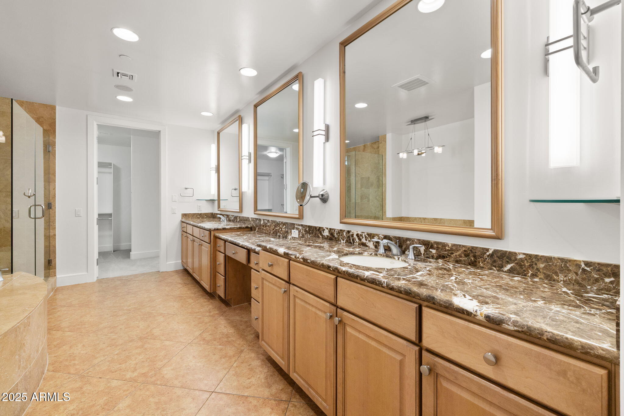 2211 East Camelback Road, Unit 607 Phoenix, AZ 85016 - Photo 19 of 41 a large bathroom with a sink and a large mirror