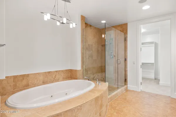 a large spacious bathroom with a granite countertop tub sink shower and mirror