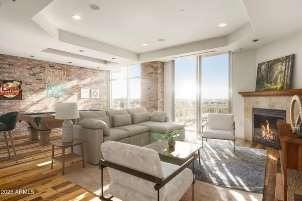 a living room with furniture large window and fireplace