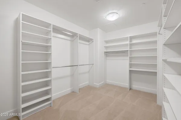 a view of walk in closet with empty racks