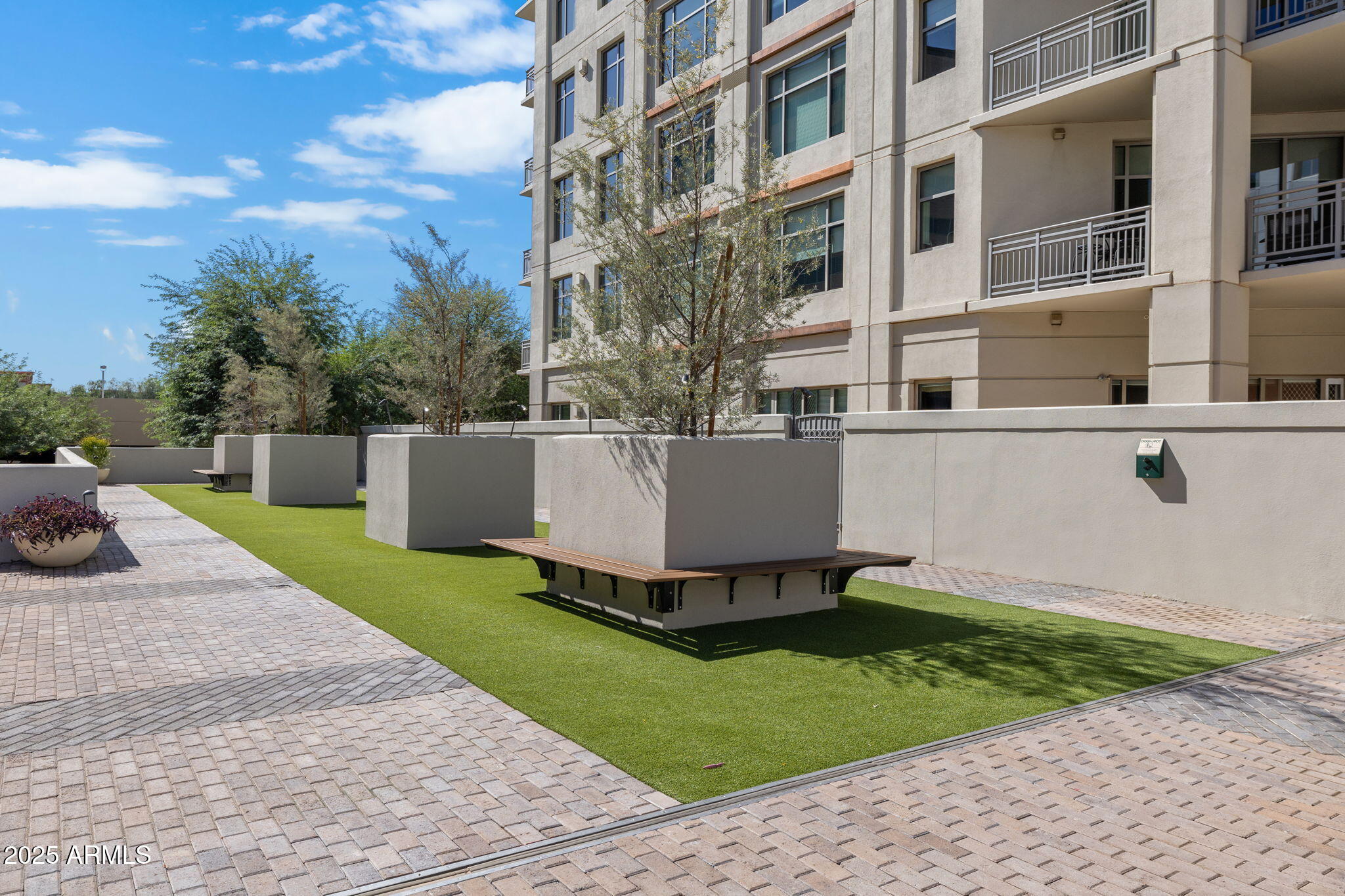 2211 East Camelback Road, Unit 607 Phoenix, AZ 85016 - Photo 27 of 41 a view of a white house with a yard and sitting area