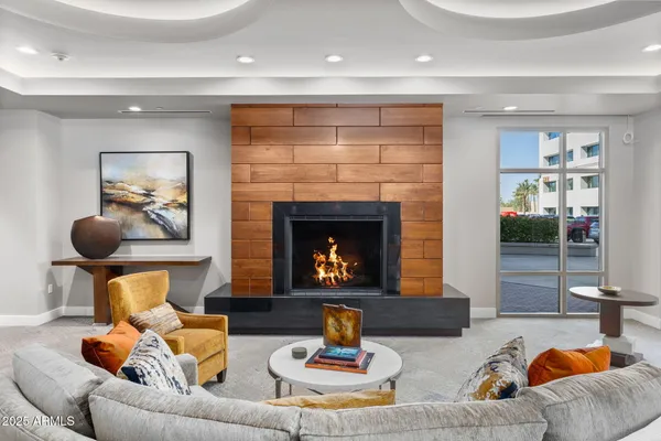 a living room with furniture a rug and white walls