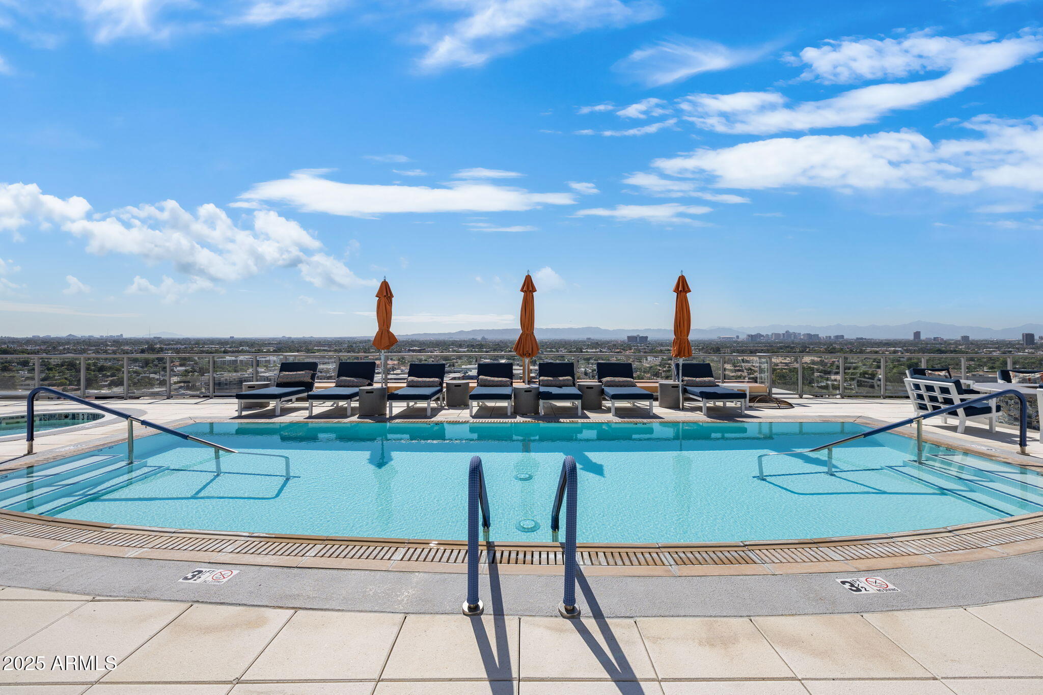 2211 East Camelback Road, Unit 607 Phoenix, AZ 85016 - Photo 34 of 41 a view of a swimming pool with a lounge chair