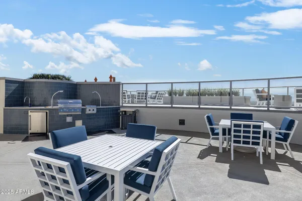 a view of an outside dining space with furniture