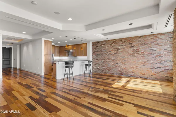 a view of an empty room with a fireplace and a window