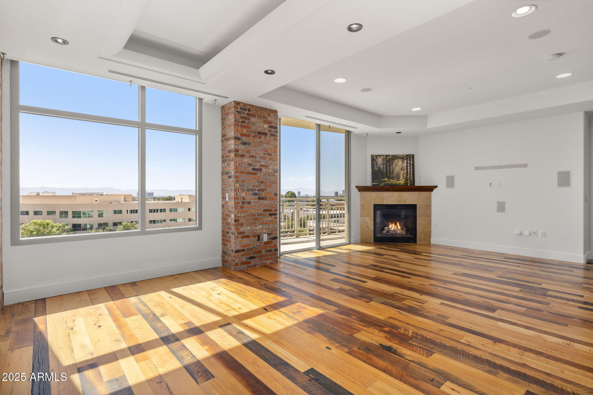 2211 East Camelback Road, Unit 607 Phoenix, AZ 85016 - Photo 9 of 41 a view of an empty room with a fireplace and a window