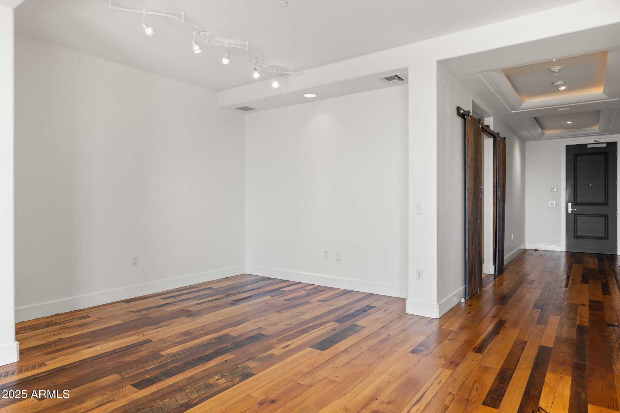 2211 East Camelback Road, Unit 607 Phoenix, AZ 85016 - Photo 10 of 41 a view of a hallway with wooden floor