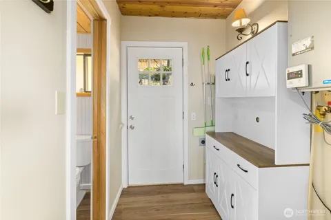 a kitchen with granite countertop white cabinets and white appliances