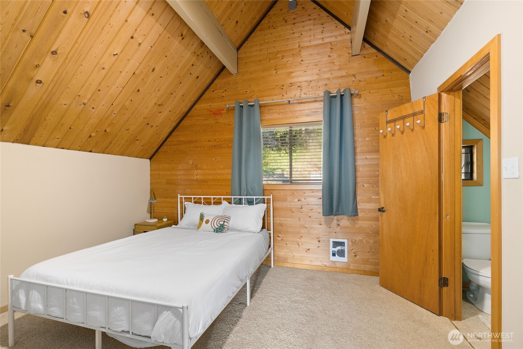 811 Horse Heaven Road Cle Elum, WA 98922 - Photo 26 of 40 a large bedroom with a bed and wooden floor